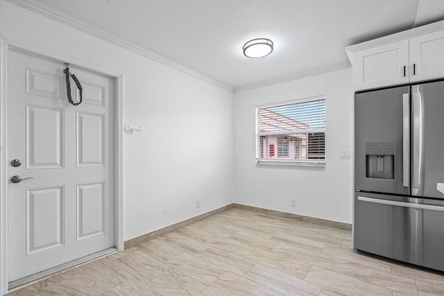 unfurnished dining area with a textured ceiling and crown molding