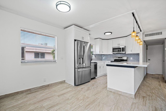 kitchen featuring a breakfast bar, hanging light fixtures, appliances with stainless steel finishes, tasteful backsplash, and white cabinetry