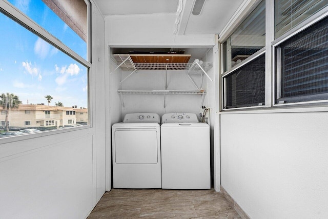 washroom featuring a wealth of natural light and washer and dryer