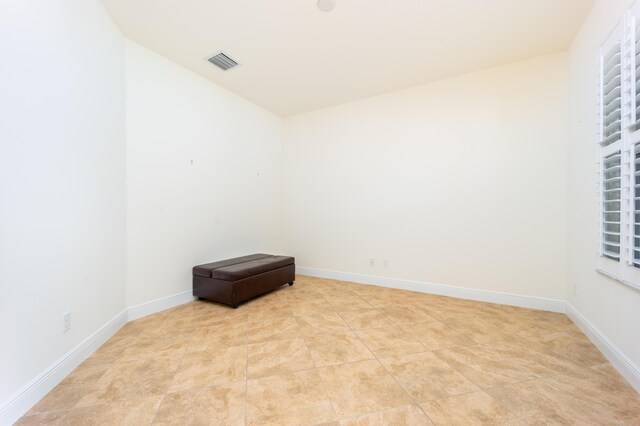 unfurnished room with light tile patterned floors