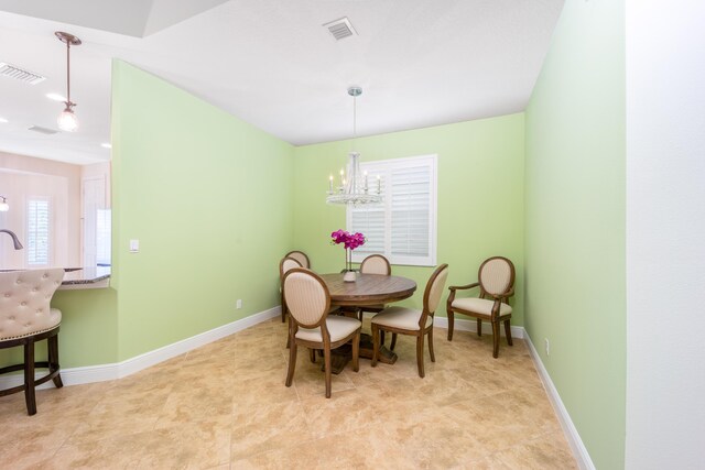 dining area featuring an inviting chandelier