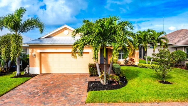 view of front of home featuring a front lawn and a garage