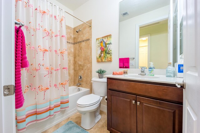 full bathroom with tile patterned flooring, vanity, toilet, and shower / bath combo with shower curtain