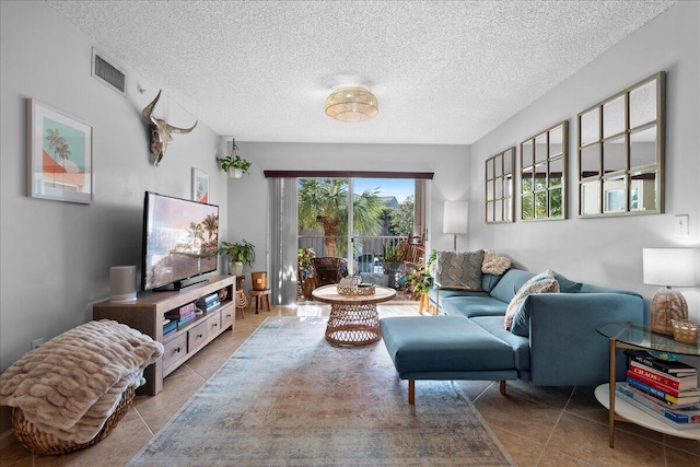 living room featuring light tile patterned floors and a textured ceiling