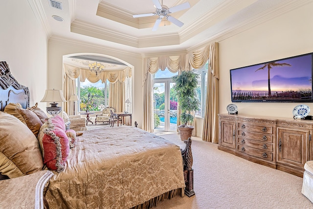 carpeted bedroom with ceiling fan with notable chandelier, a raised ceiling, and ornamental molding