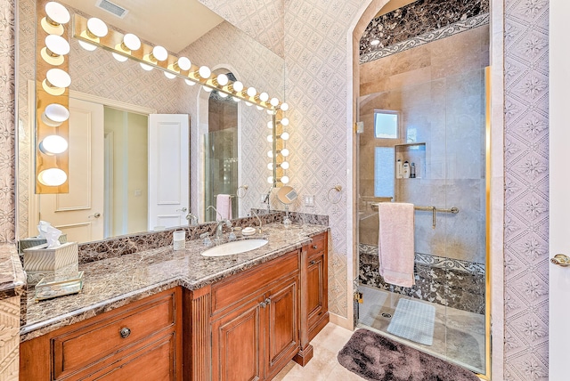 bathroom with a shower and vanity