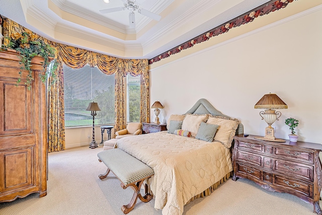 carpeted bedroom featuring a tray ceiling, ceiling fan, and ornamental molding