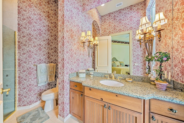 bathroom featuring tile patterned flooring, vanity, and toilet