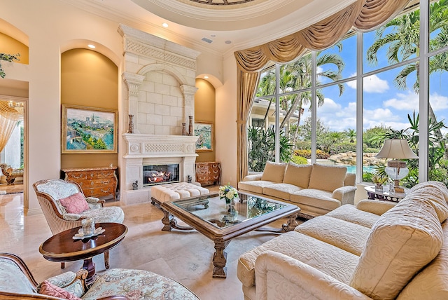 interior space featuring a fireplace, a high ceiling, and crown molding