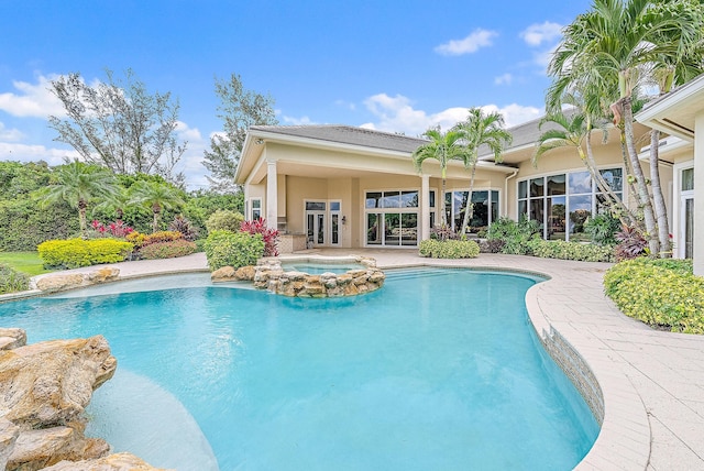 view of pool featuring an in ground hot tub and french doors