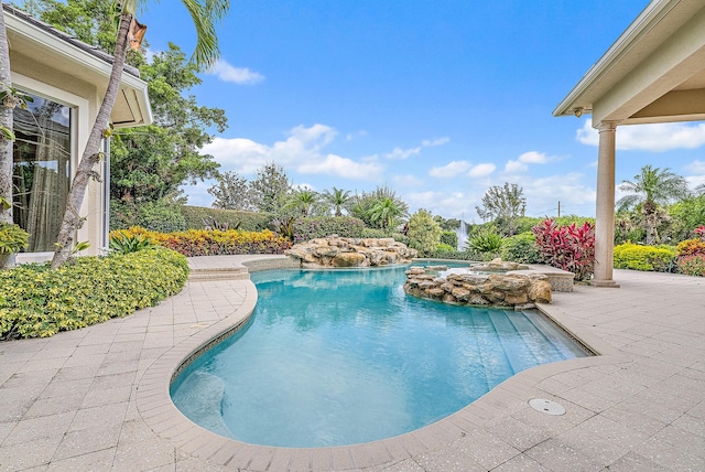 view of swimming pool featuring an in ground hot tub and a patio area