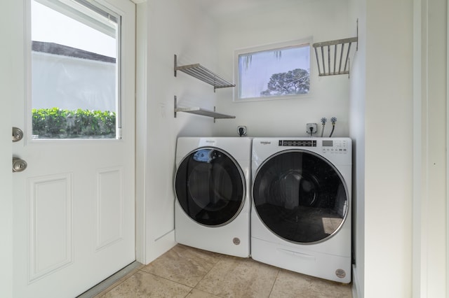 laundry room featuring washer and clothes dryer and light tile patterned flooring