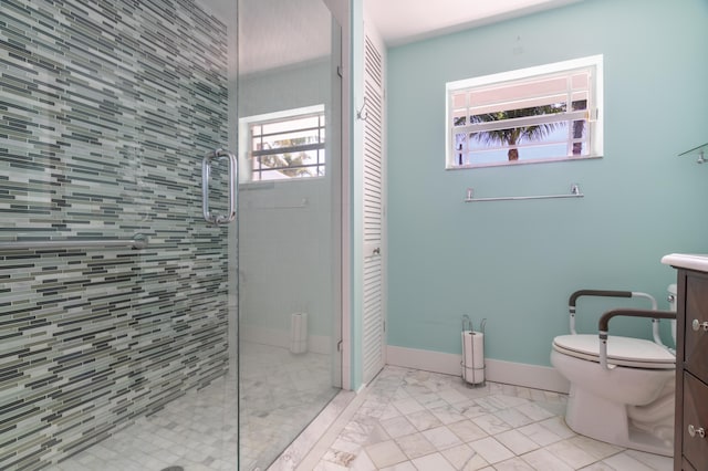 bathroom with vanity, a healthy amount of sunlight, a shower with shower door, and toilet