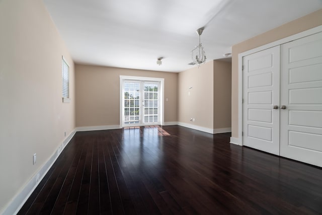 interior space with dark hardwood / wood-style floors and a notable chandelier