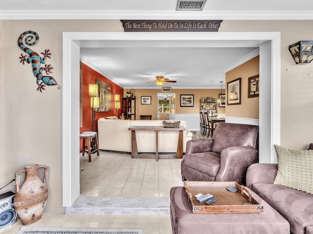 tiled living room featuring ceiling fan and crown molding