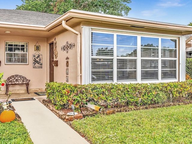 doorway to property with stucco siding