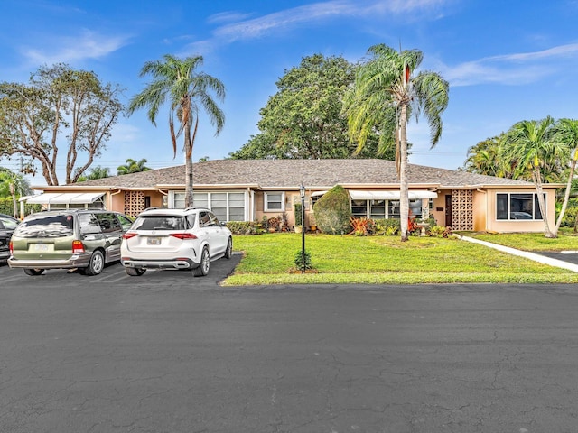 ranch-style home featuring a front yard