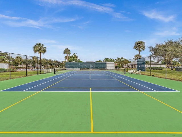 view of tennis court featuring basketball hoop