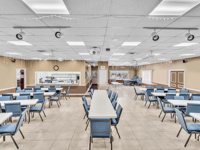 dining room with a drop ceiling and ceiling fan