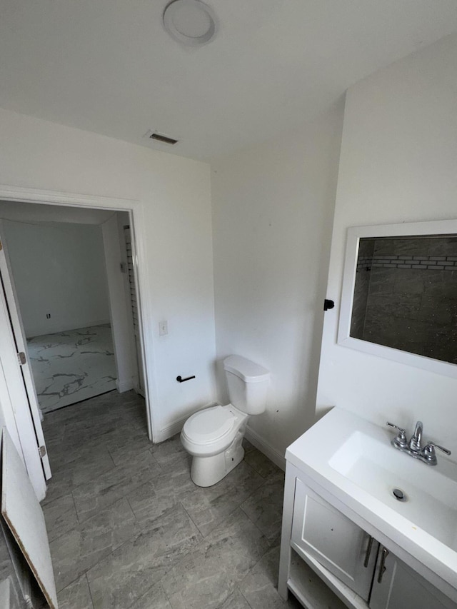 bathroom featuring toilet and sink