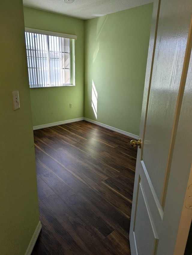 unfurnished room featuring dark hardwood / wood-style floors