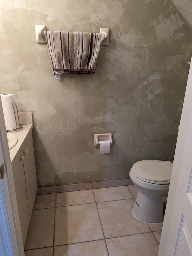 bathroom featuring tile patterned flooring, vanity, and toilet