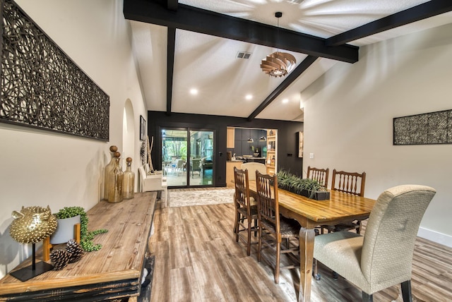 dining area with vaulted ceiling with beams and hardwood / wood-style floors