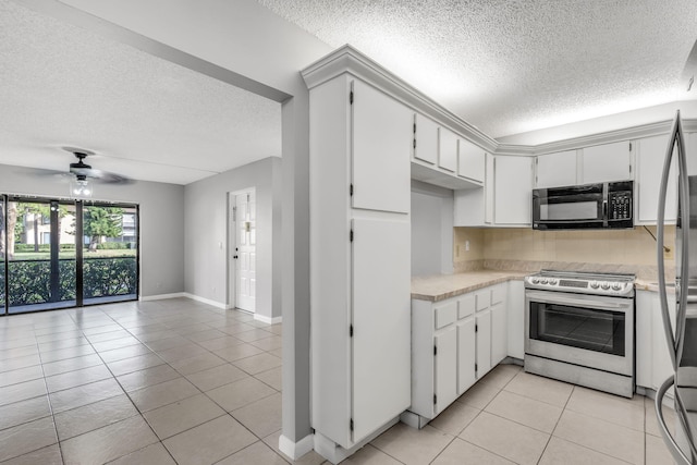 kitchen with decorative backsplash, stainless steel electric stove, ceiling fan, white cabinets, and light tile patterned flooring