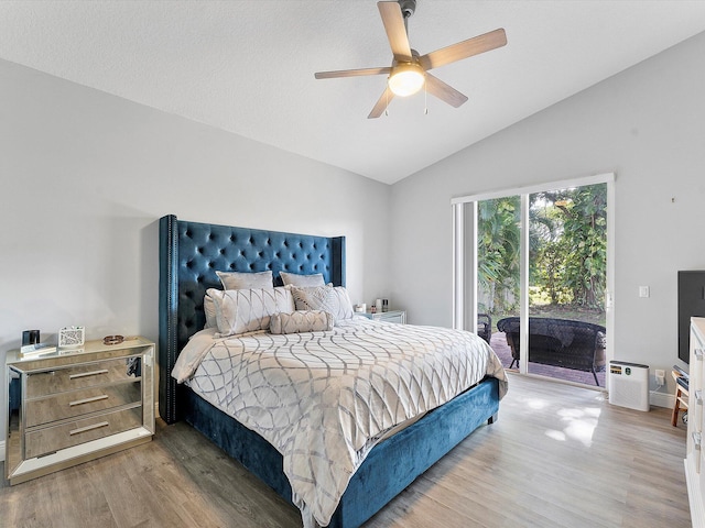 bedroom featuring access to exterior, ceiling fan, wood-type flooring, and lofted ceiling