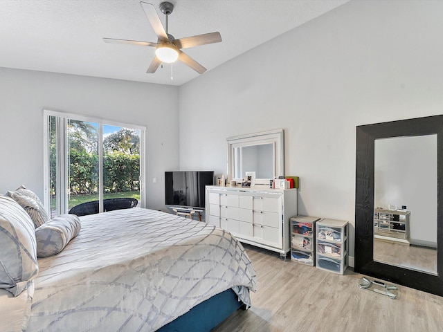 bedroom with ceiling fan, a textured ceiling, lofted ceiling, access to outside, and light wood-type flooring