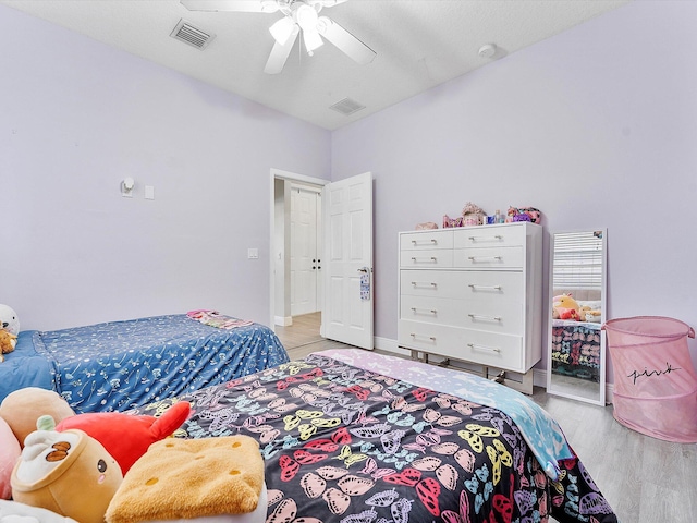 bedroom featuring ceiling fan and light hardwood / wood-style flooring