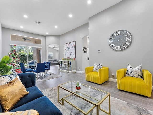 living room with ceiling fan and hardwood / wood-style flooring