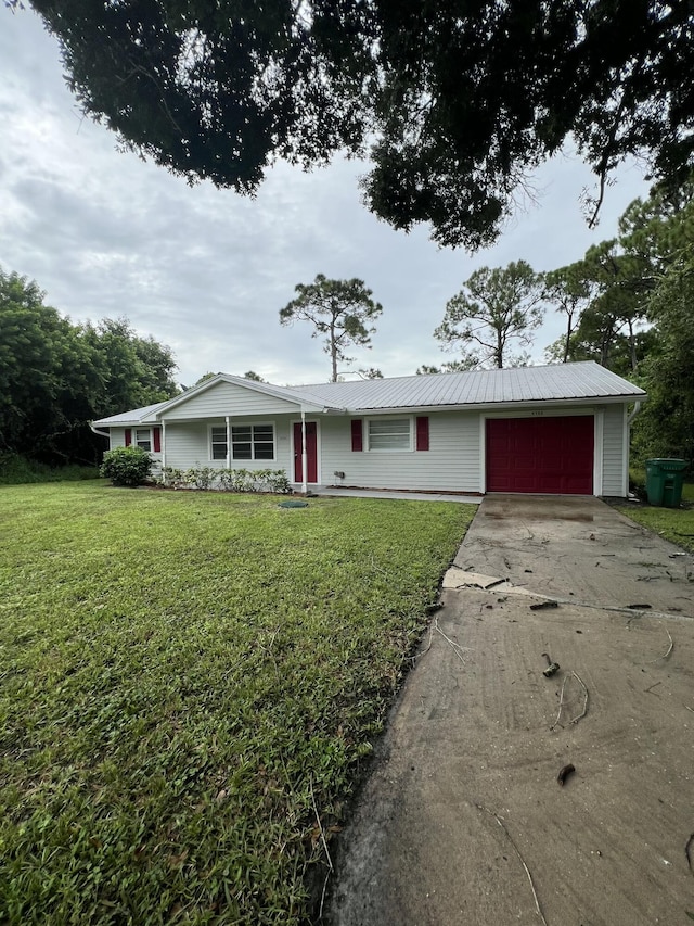 ranch-style home featuring a garage and a front lawn