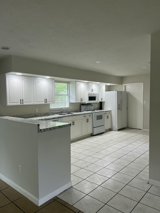 kitchen featuring sink, white cabinets, stone countertops, white appliances, and light tile patterned flooring