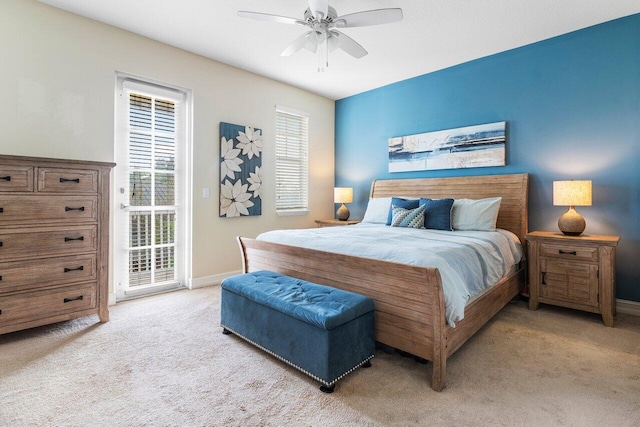 carpeted bedroom with ceiling fan and multiple windows