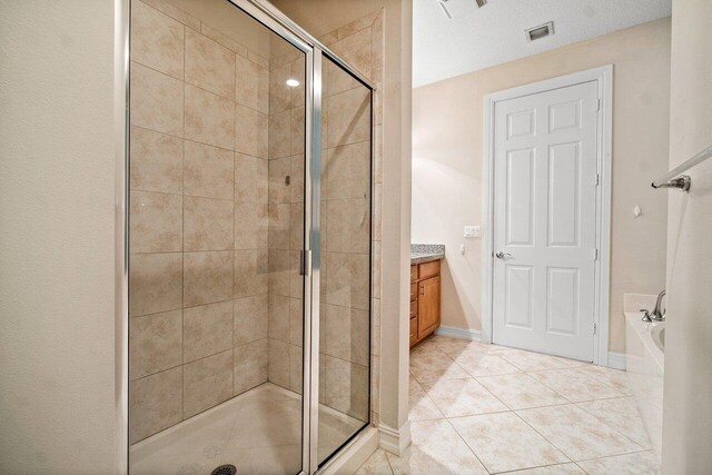 bathroom with vanity, tile patterned flooring, and independent shower and bath