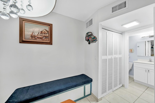 hallway with sink and light tile patterned floors