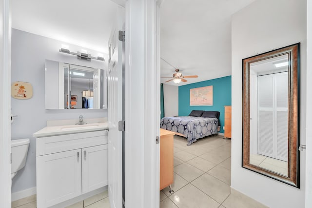 interior space with ceiling fan, light tile patterned floors, and sink