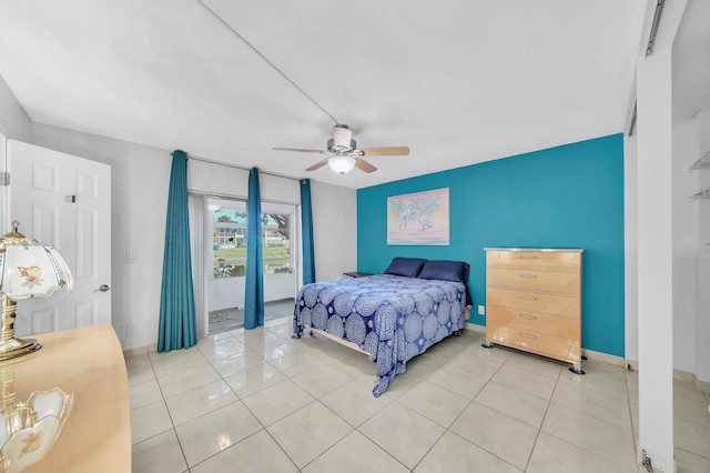 bedroom with light tile patterned floors, access to outside, and ceiling fan