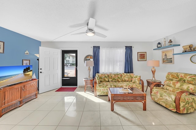 tiled living room with a textured ceiling and ceiling fan