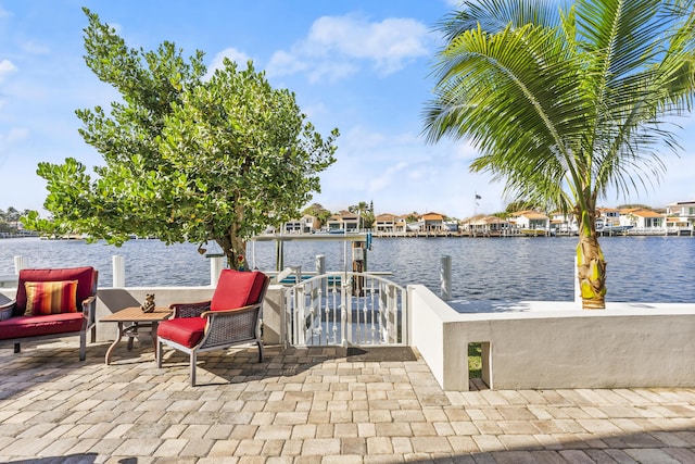 view of patio with a water view and a boat dock