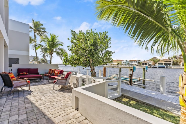 view of patio with a water view, an outdoor hangout area, and a boat dock