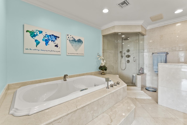 bathroom with ornamental molding and separate shower and tub