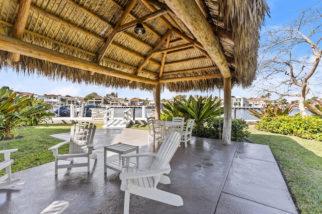 view of patio featuring a gazebo and a water view