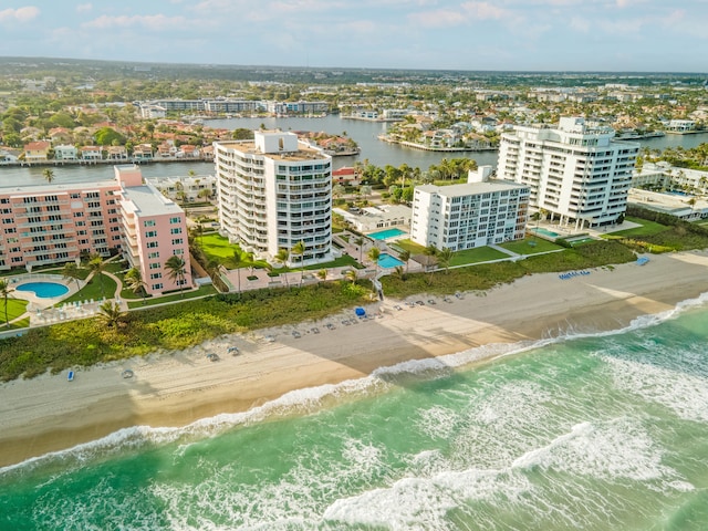 drone / aerial view featuring a water view and a beach view