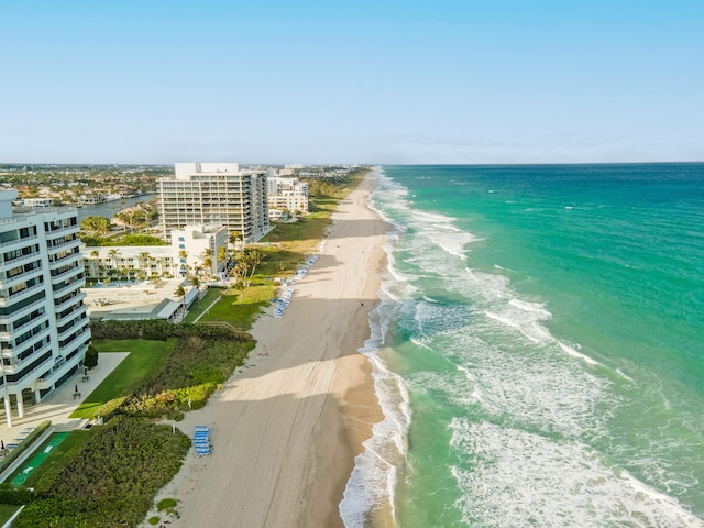 drone / aerial view with a water view and a beach view