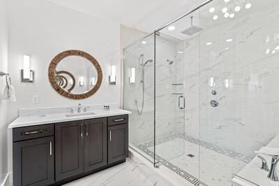 bathroom with vanity and a shower with door