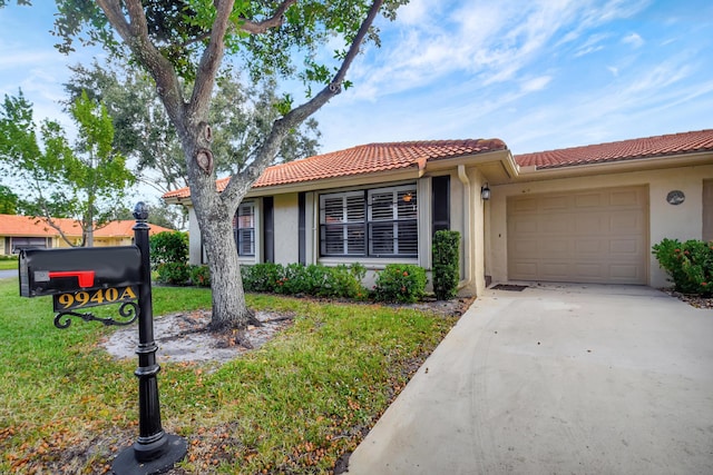 view of front facade with a front yard and a garage