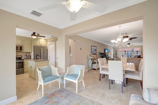 tiled dining room featuring ornamental molding and a chandelier