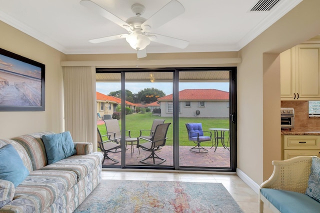 living room featuring plenty of natural light, ceiling fan, light tile patterned floors, and crown molding